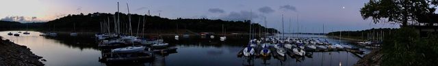 Beautiful wide angle shot, taken from d dock pillar, stetches far east mooring to b dock,  sunrise on the moring to the moon setting over c dock, calm, twilight